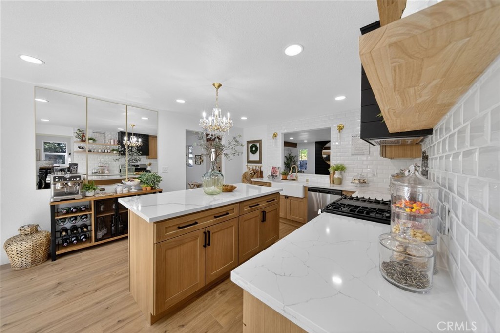 1171 Bear Springs Road Rimforest, CA 92378 - Photo 28 of 43 a kitchen with stainless steel appliances a sink a stove top oven a counter space and cabinets