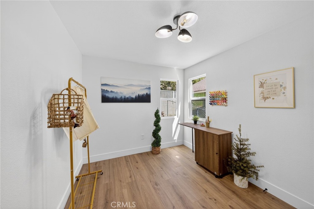 1171 Bear Springs Road Rimforest, CA 92378 - Photo 31 of 43 a view of a workspace with furniture and wooden floor