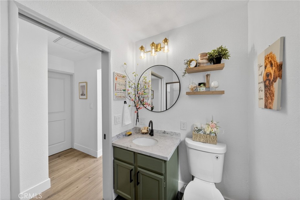 1171 Bear Springs Road Rimforest, CA 92378 - Photo 32 of 43 a bathroom with a toilet a sink and a mirror