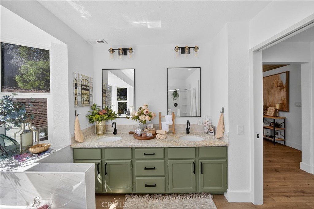 1171 Bear Springs Road Rimforest, CA 92378 - Photo 37 of 43 a bathroom with double vanity sinks a vanity a mirror and a shower