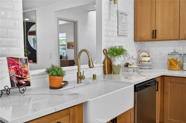 a kitchen area with lots of clutter and cabinets