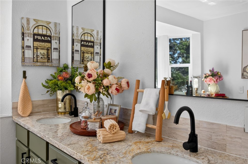 1171 Bear Springs Road Rimforest, CA 92378 - Photo 8 of 43 a close view of a faucet a potted plant and a counter space
