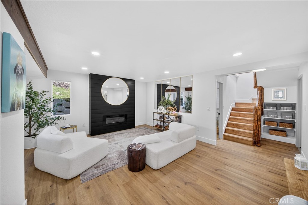 1171 Bear Springs Road Rimforest, CA 92378 - Photo 10 of 43 a living room with furniture a lamp and wooden floor