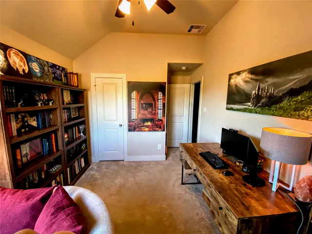 a living room with furniture and a book shelf