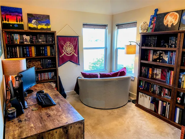 a living room with furniture and book shelf