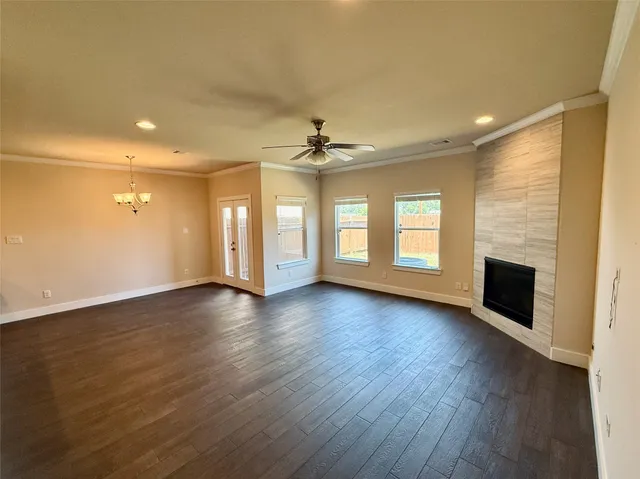 a view of an empty room with a fireplace and a window