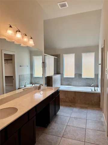 a bathroom with a sink vanity and mirror