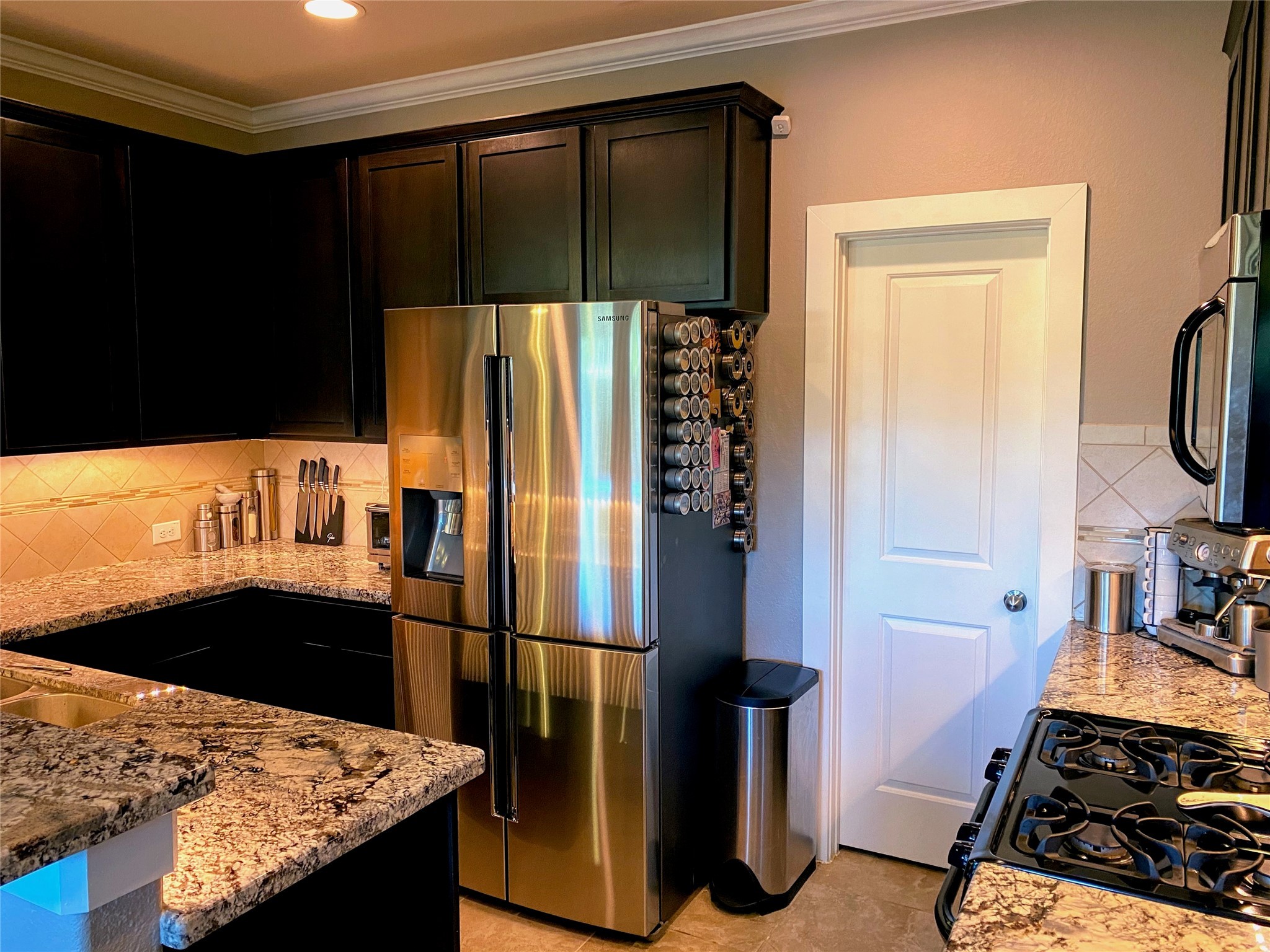 1842 Jara Court Spring, TX 77388 - Photo 7 of 31 a kitchen with a refrigerator and a stove