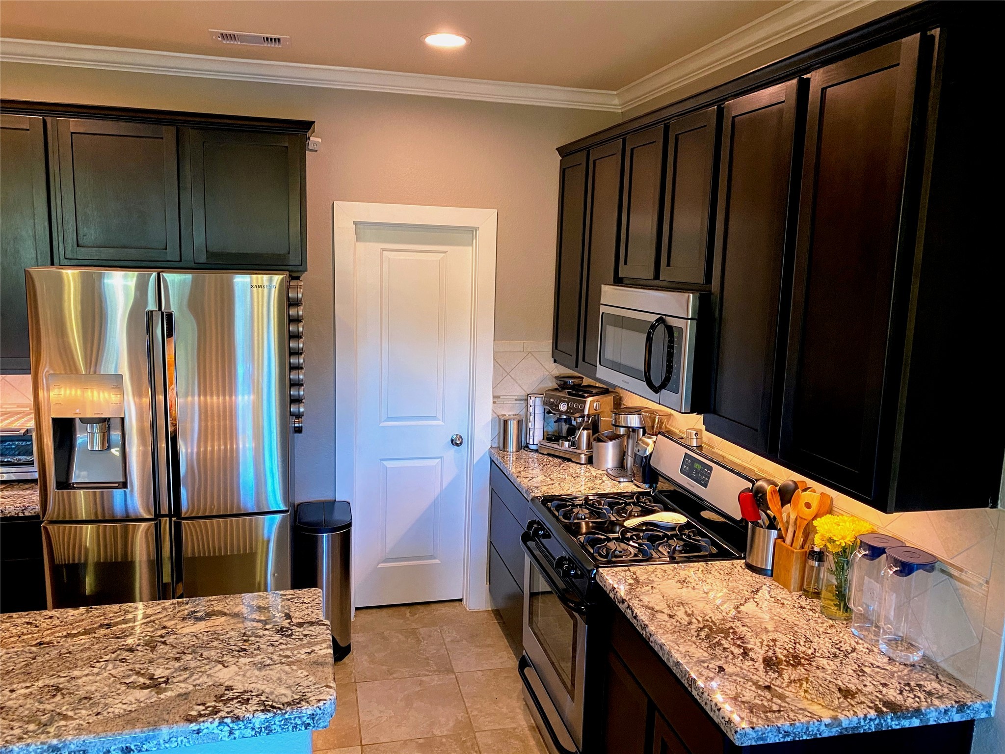 1842 Jara Court Spring, TX 77388 - Photo 9 of 31 a kitchen with stainless steel appliances granite countertop wooden cabinets a stove top oven