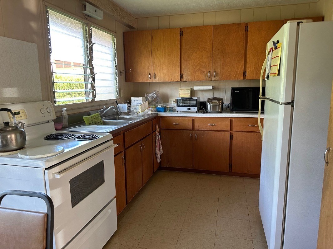 4850 Yamanoha Road Kapaa, HI 96746 - Photo 8 of 22 a kitchen with stainless steel appliances a stove a sink and a refrigerator