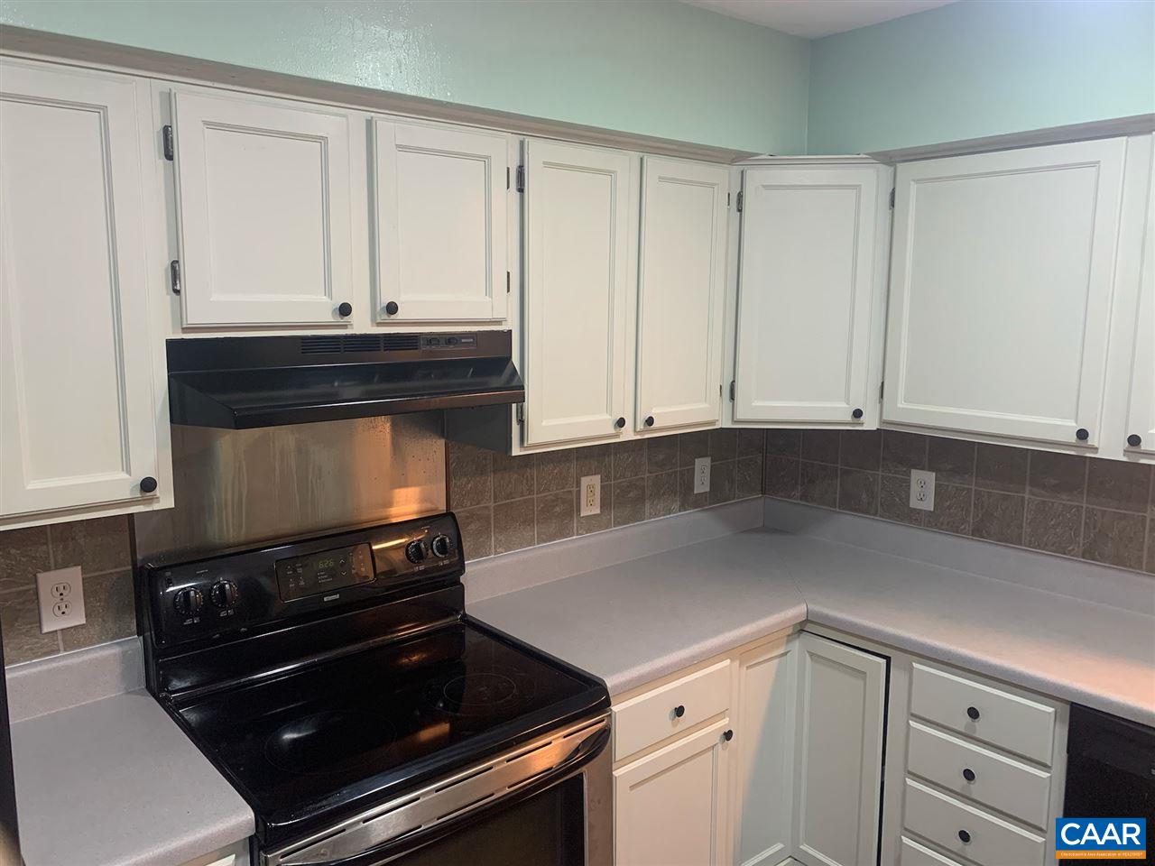 5 East Point Road Palmyra, VA 22963 - Photo 8 of 20 a kitchen with granite countertop white cabinets and black appliances