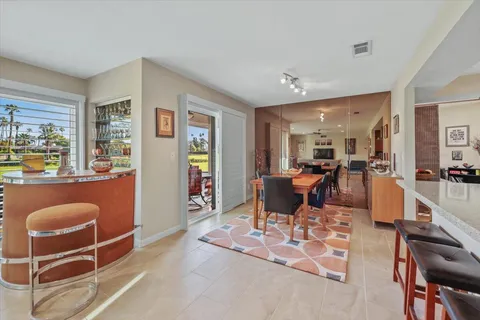 a living room with furniture a dining table and chairs