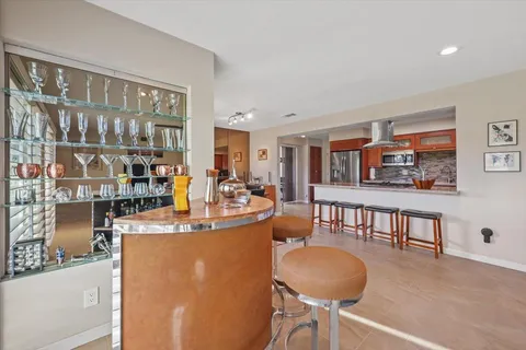 a dining room with furniture and a floor to ceiling window