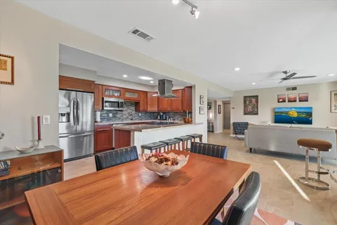 a large kitchen with a table and chairs