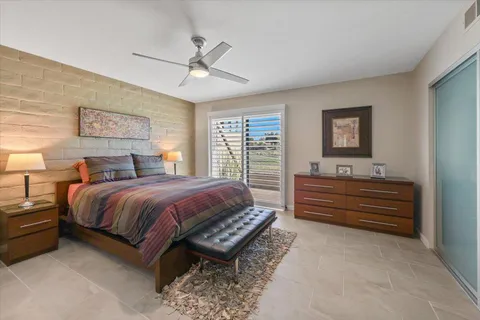 a spacious bedroom with a bed and a dresser