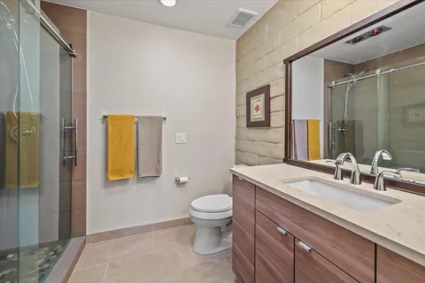 a bathroom with a sink a toilet and a large mirror