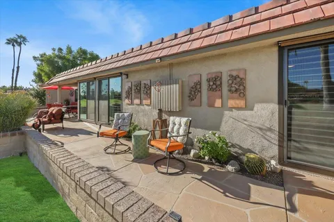 a view of house with patio outdoor seating and plants