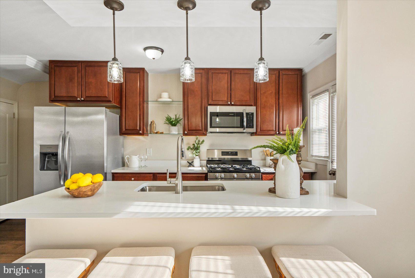 1283 Cedarcroft Road Baltimore, MD 21239 - Photo 12 of 39 a kitchen with a refrigerator a microwave and sink
