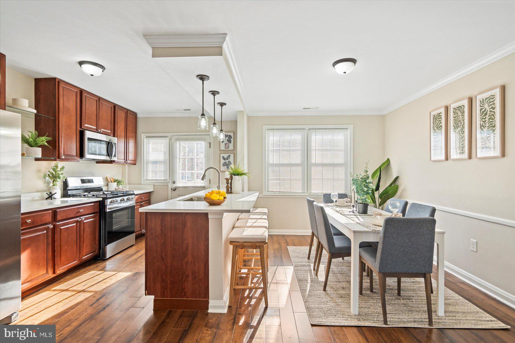 1283 Cedarcroft Road Baltimore, MD 21239 - Photo 13 of 39 a dining room filled counter top space a large window and stainless steel appliances