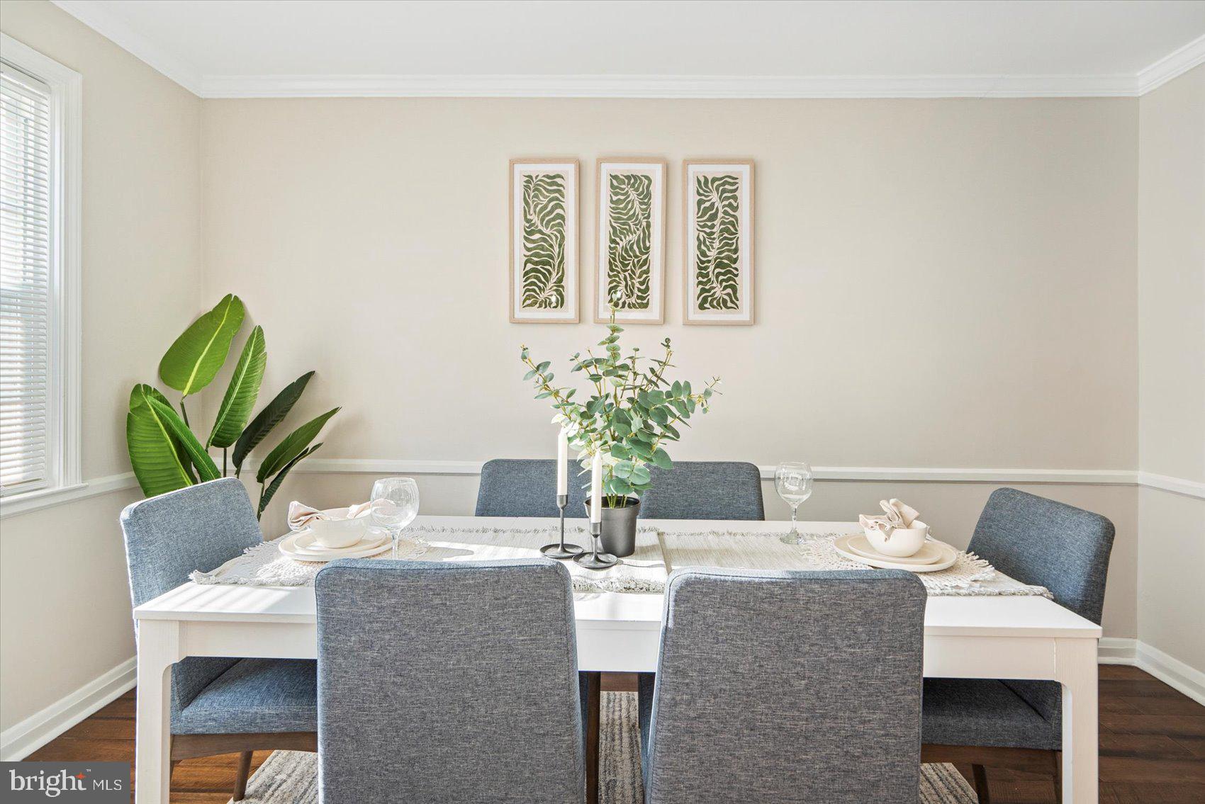1283 Cedarcroft Road Baltimore, MD 21239 - Photo 16 of 39 a dining room with furniture and wooden floor