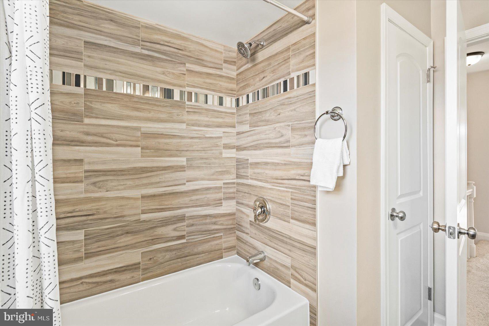 1283 Cedarcroft Road Baltimore, MD 21239 - Photo 24 of 39 a bathroom with a bathtub and shower