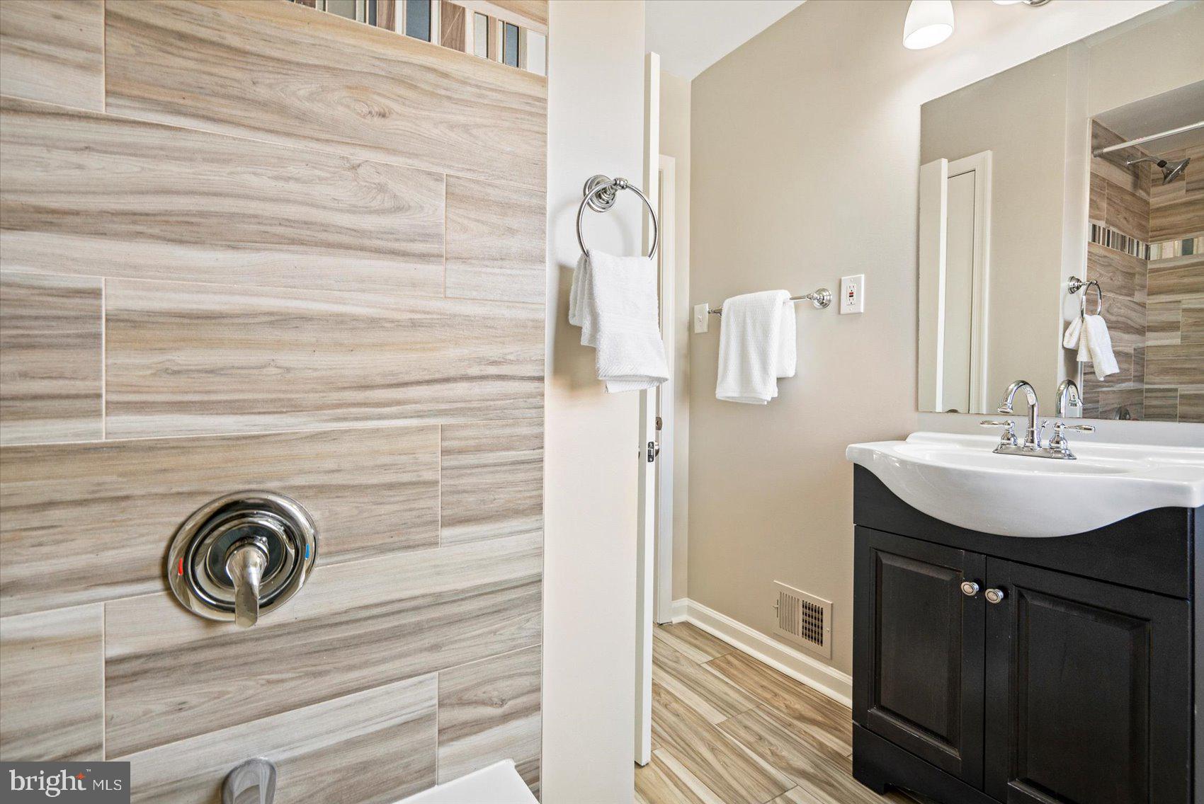 1283 Cedarcroft Road Baltimore, MD 21239 - Photo 25 of 39 a bathroom with a sink and a mirror