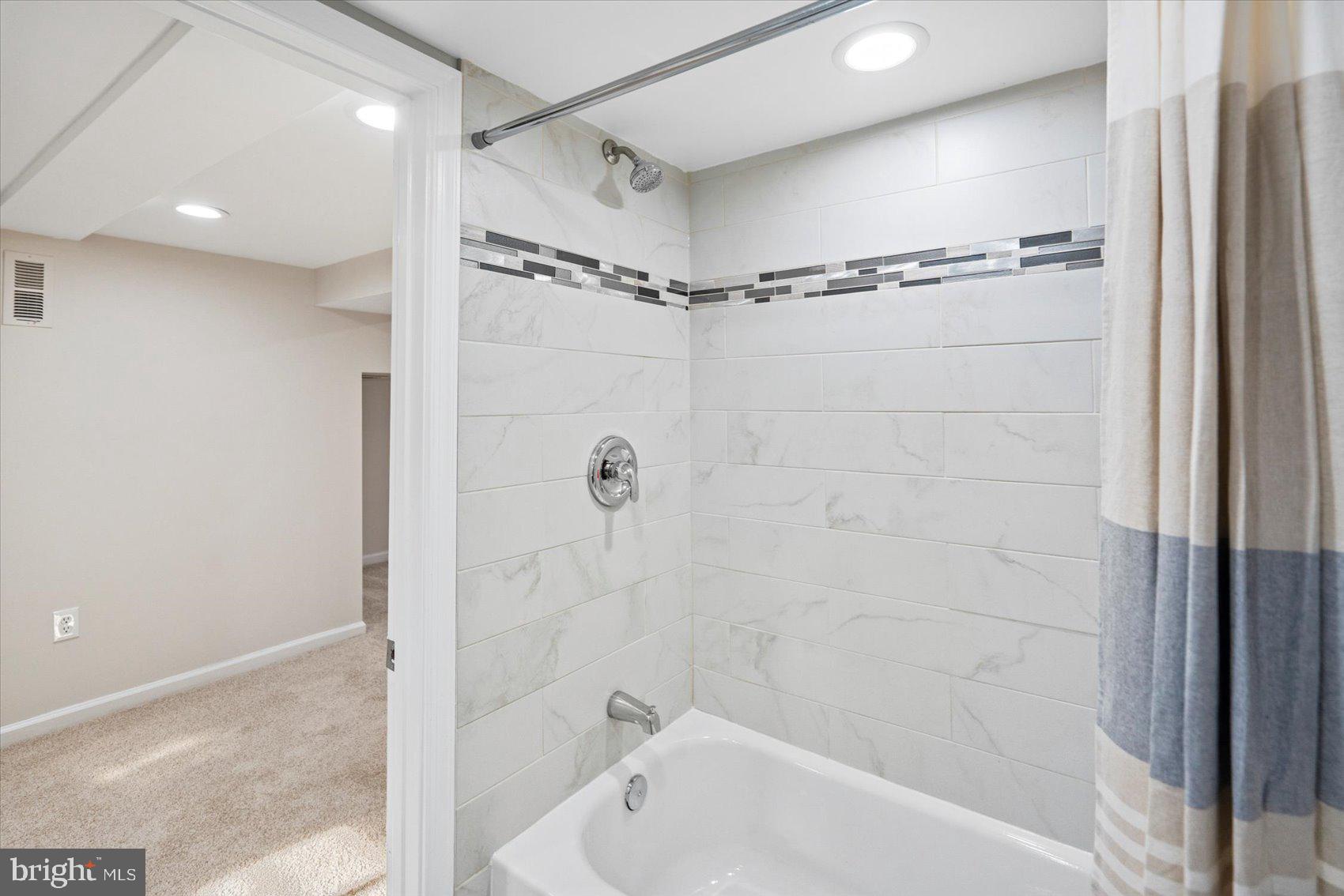 1283 Cedarcroft Road Baltimore, MD 21239 - Photo 34 of 39 a bathroom with a bathtub and a shower