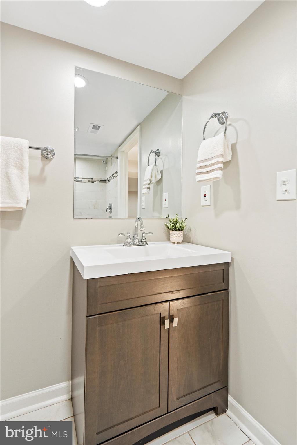 1283 Cedarcroft Road Baltimore, MD 21239 - Photo 35 of 39 a room with a sink and a mirror