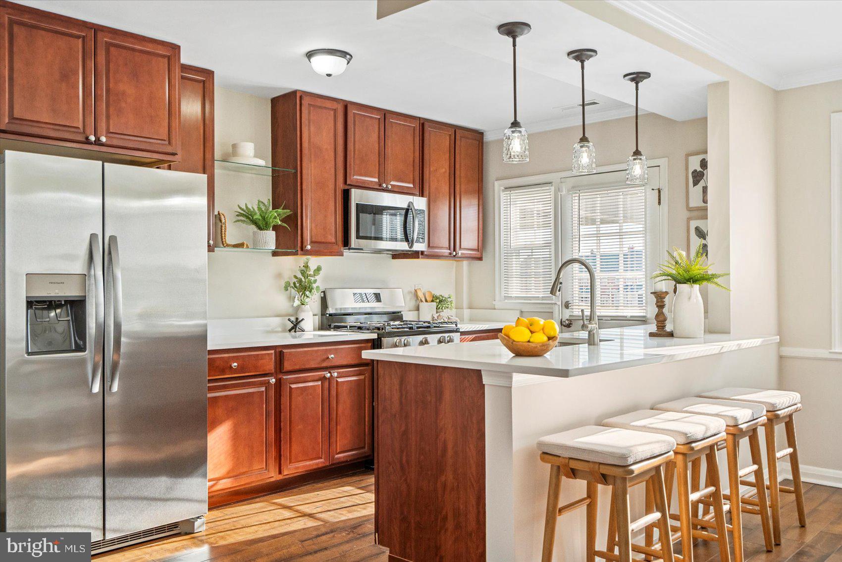 1283 Cedarcroft Road Baltimore, MD 21239 - Photo 8 of 39 a kitchen with stainless steel appliances granite countertop a sink refrigerator and cabinets