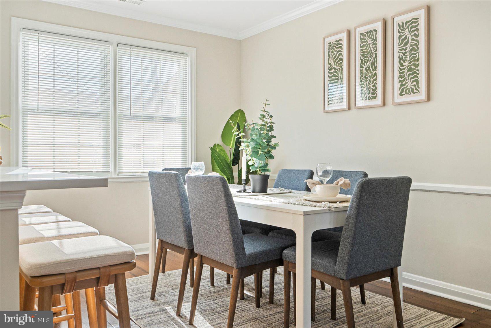 1283 Cedarcroft Road Baltimore, MD 21239 - Photo 9 of 39 a view of a dining room with furniture and a potted plant