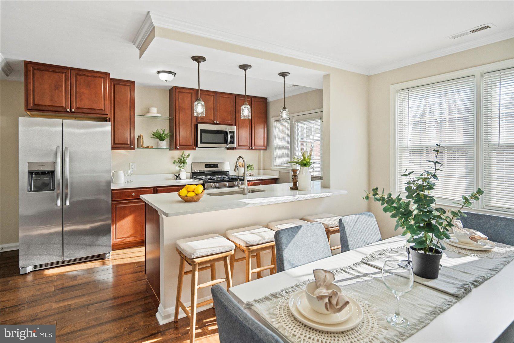 1283 Cedarcroft Road Baltimore, MD 21239 - Photo 10 of 39 a kitchen with a table and chairs in it