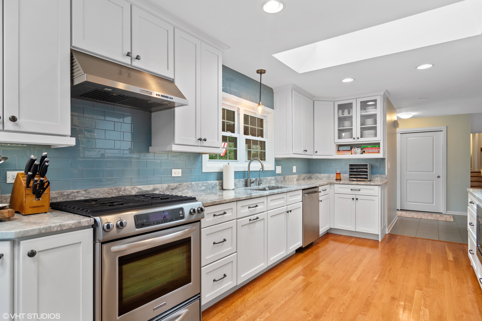 1601 Banbury Road Inverness, IL 60067 - Photo 11 of 36 a kitchen with granite countertop stainless steel appliances a stove and white cabinets