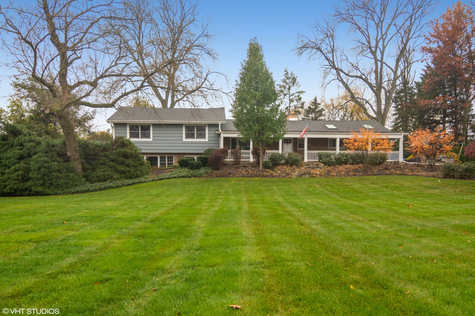 1601 Banbury Road Inverness, IL 60067 - Photo 3 of 36 a front view of a house with a garden and trees
