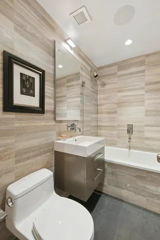 a bathroom with a sink a toilet and bathtub