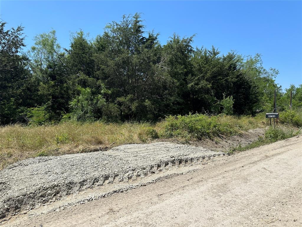 9798 County Road 146 Kaufman, TX 75142 - Photo 1 of 1 a view of a dirt road with a building in the background