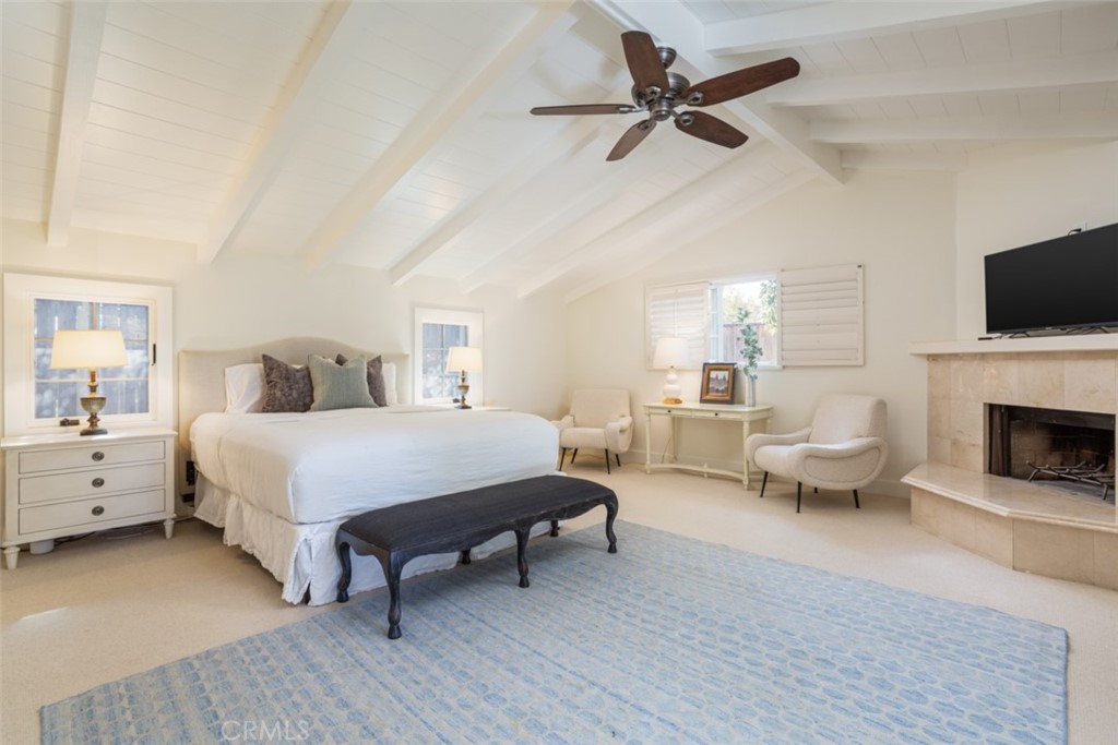 1941 Commodore Road Newport Beach, CA 92660 - Photo 15 of 35 a spacious bedroom with a bed a couch and a flat screen tv