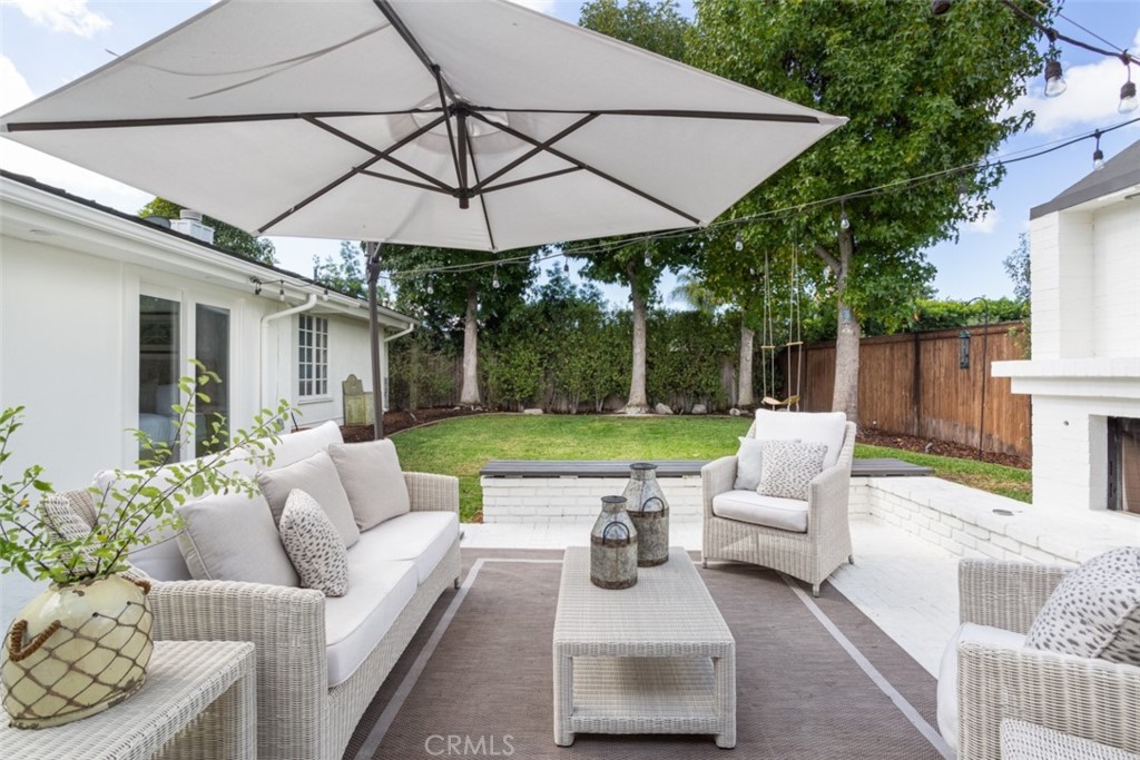 1941 Commodore Road Newport Beach, CA 92660 - Photo 26 of 35 a view of a patio with couches and table and chairs under an umbrella