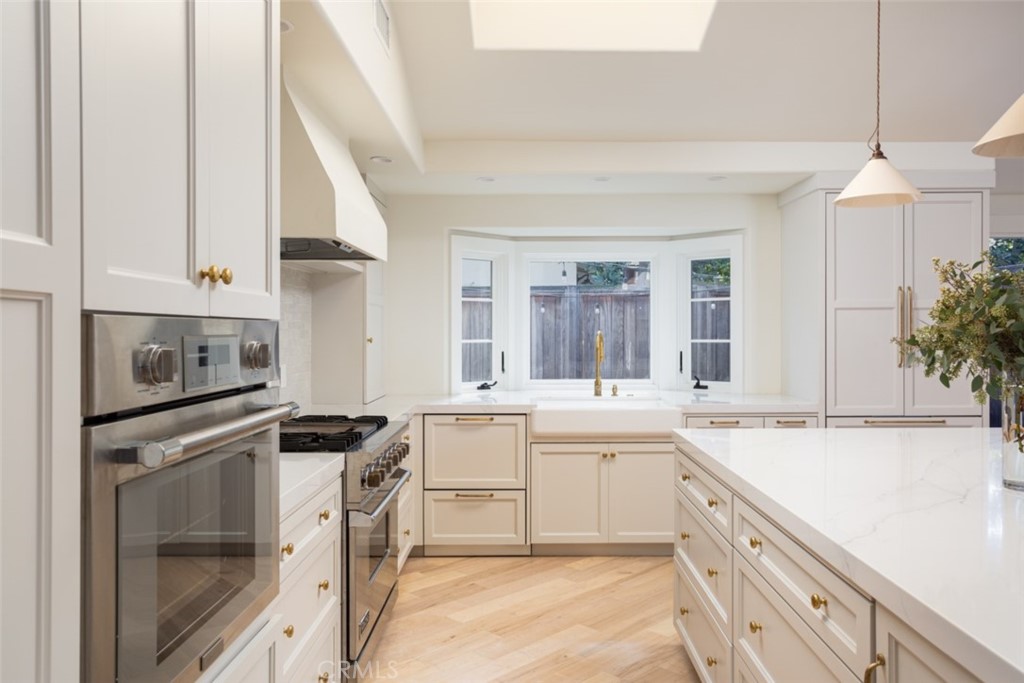 1941 Commodore Road Newport Beach, CA 92660 - Photo 8 of 35 a kitchen with a sink stove and cabinets