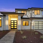 a front view of a house with large windows