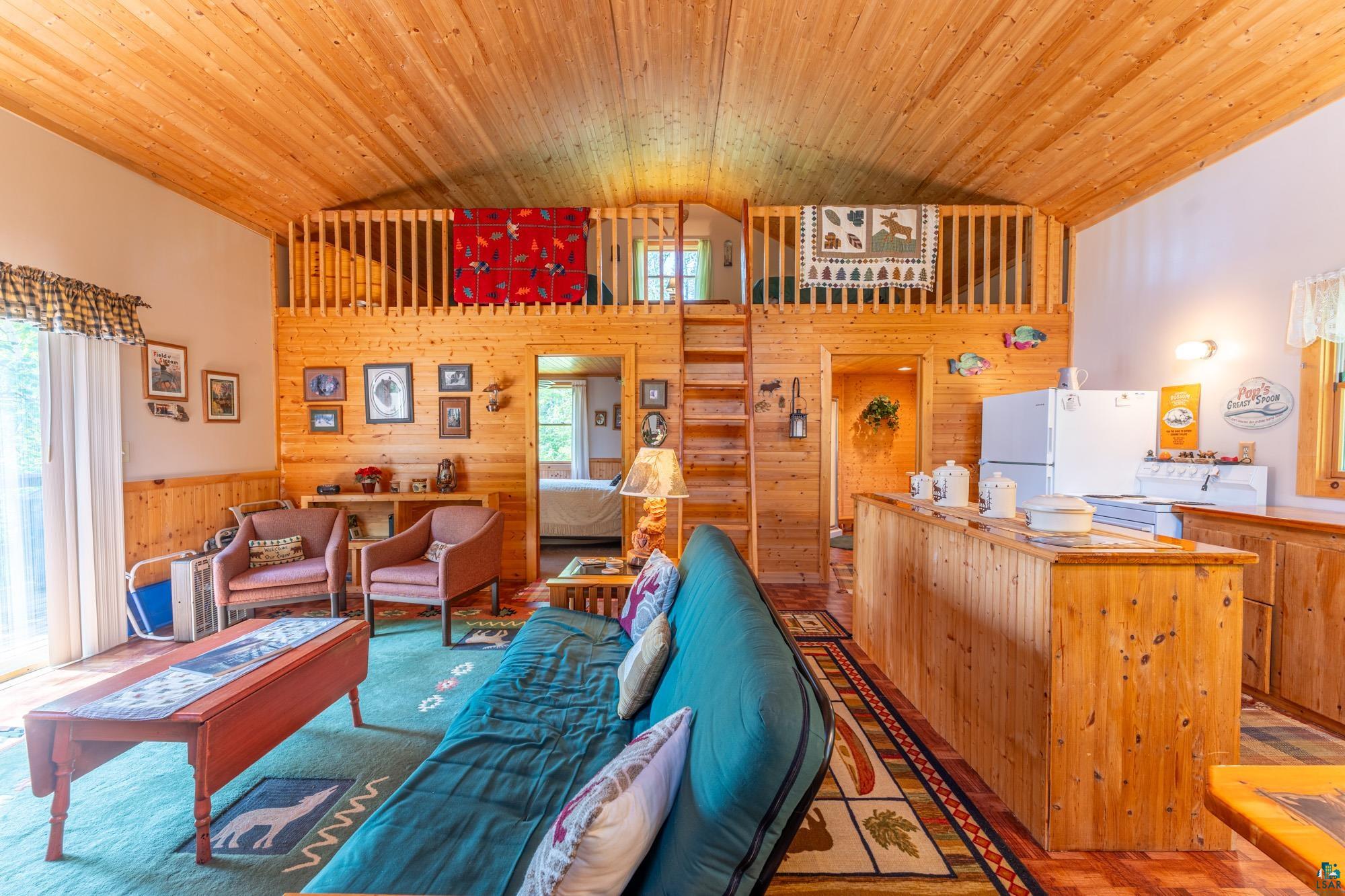 296 Shady Lane Ely, MN 55731 - Photo 12 of 27 Living room featuring wood ceiling, high vaulted ceiling, and plenty of natural light