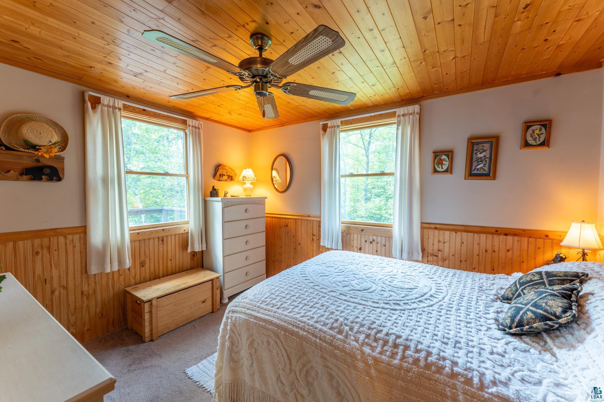 296 Shady Lane Ely, MN 55731 - Photo 13 of 27 Carpeted bedroom with wooden ceiling and ceiling fan