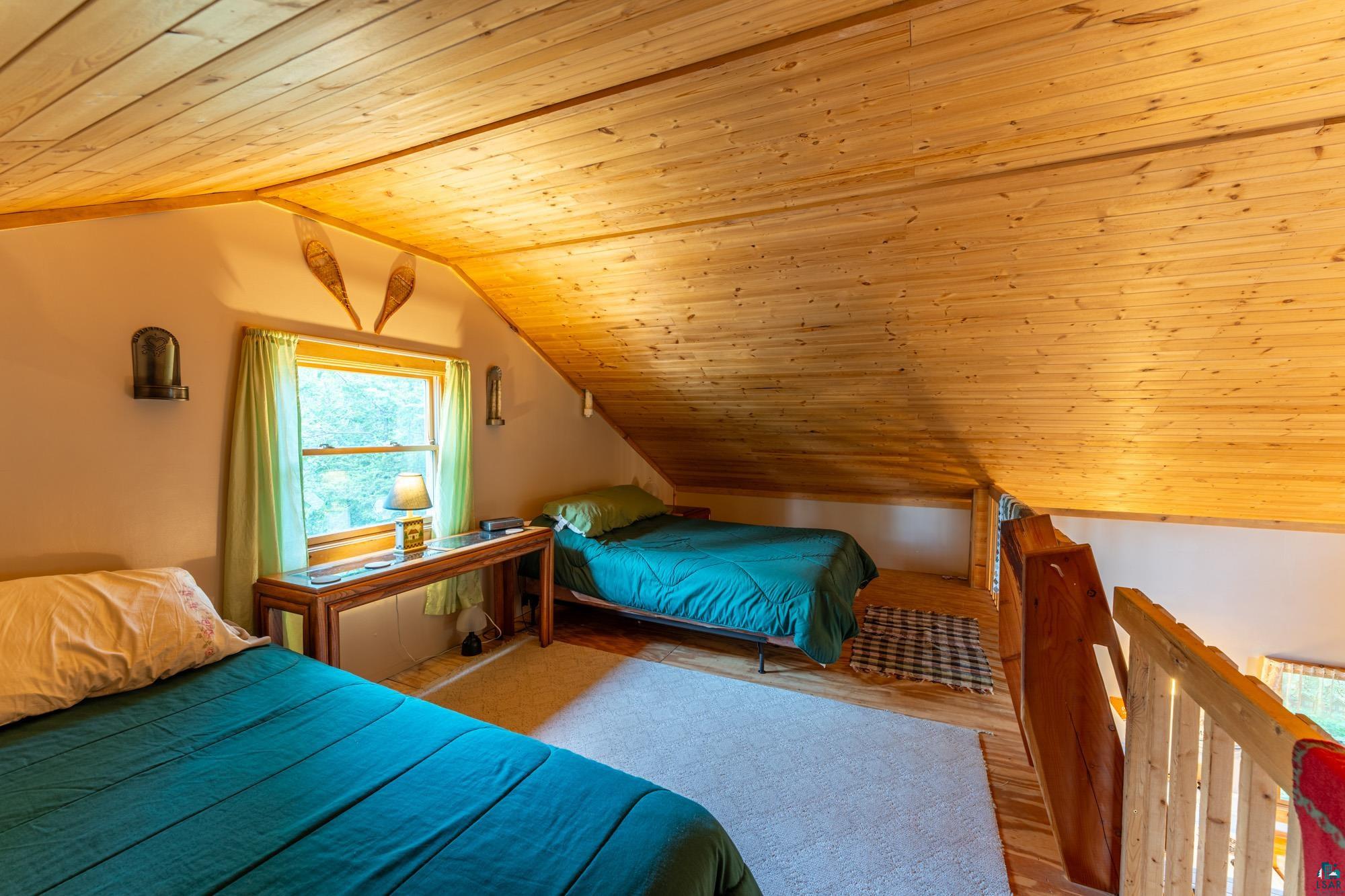 296 Shady Lane Ely, MN 55731 - Photo 15 of 27 Bedroom with wood ceiling, hardwood / wood-style flooring, and vaulted ceiling