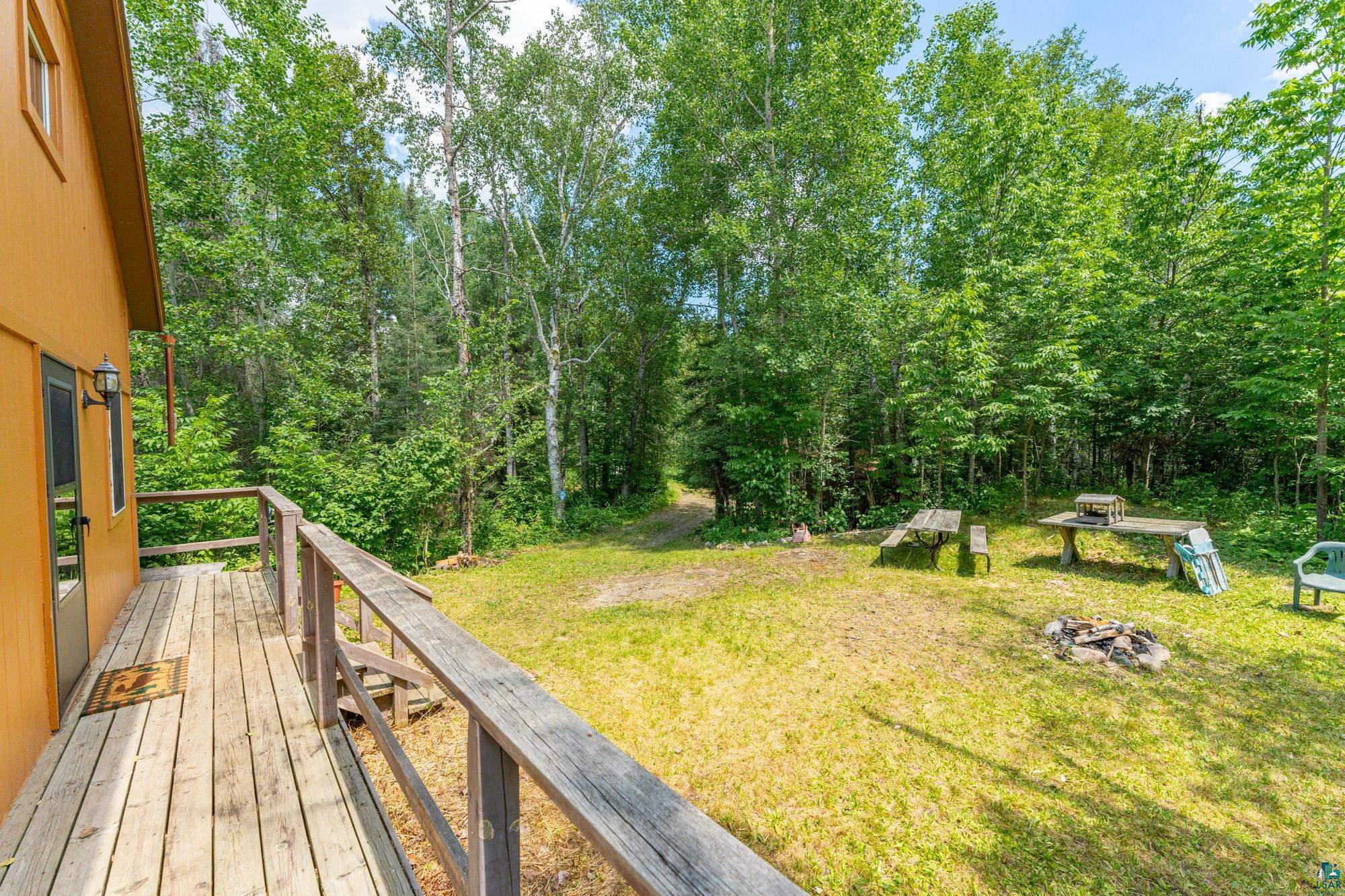 296 Shady Lane Ely, MN 55731 - Photo 18 of 27 Wooden terrace featuring a lawn
