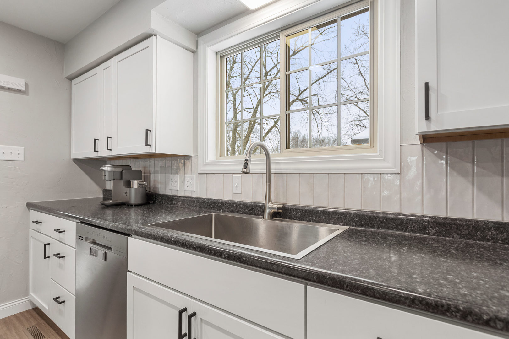 706 Madison Street Monticello, IL 61856 - Photo 11 of 38 a kitchen with stainless steel appliances granite countertop white cabinets and a sink