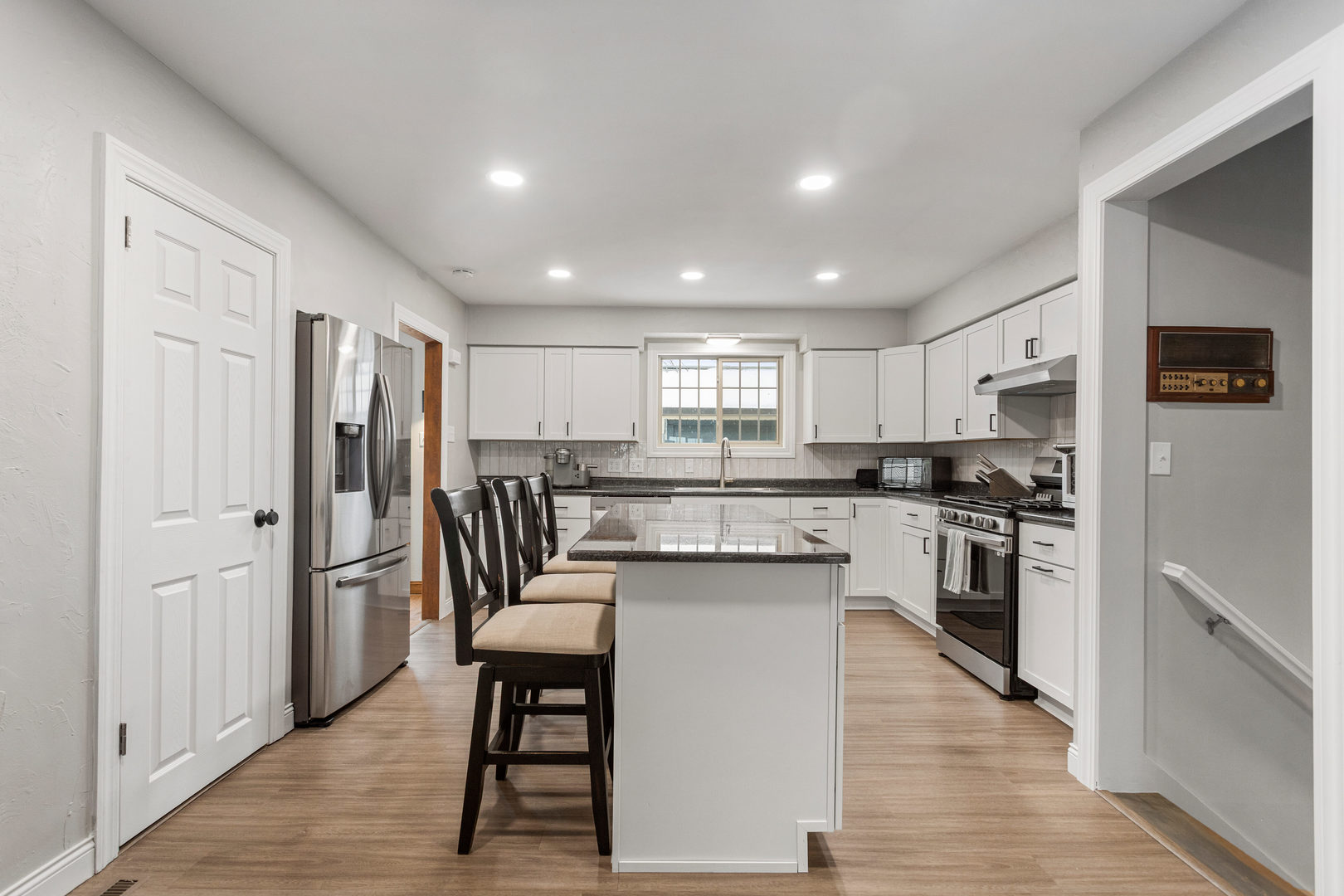 706 Madison Street Monticello, IL 61856 - Photo 6 of 38 a kitchen with stainless steel appliances granite countertop a refrigerator a stove top oven a sink and dishwasher