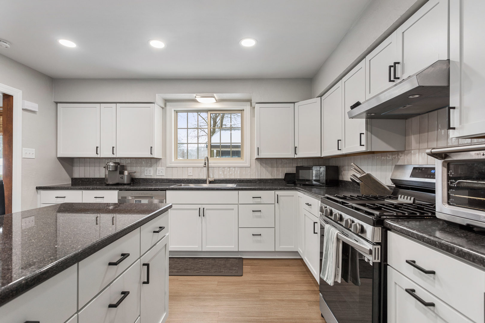 706 Madison Street Monticello, IL 61856 - Photo 8 of 38 a kitchen with stainless steel appliances granite countertop a sink a stove and cabinets