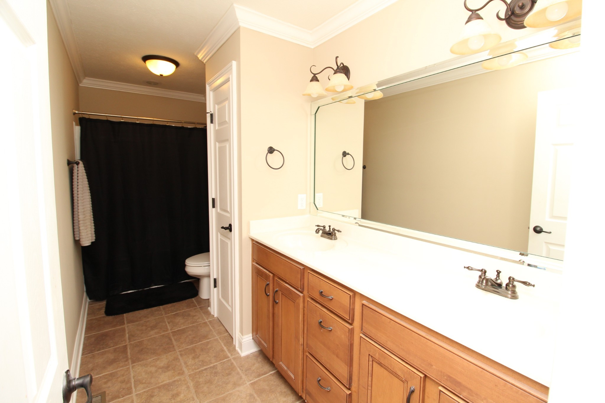 135 Excell Road, Unit 1401 Clarksville, TN 37043 - Photo 8 of 12 a bathroom with a double vanity sink toilet and shower