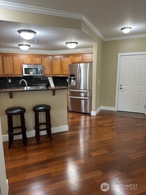 23943 Northeast 115th Lane, Unit 204 Redmond, WA 98053 - Photo 9 of 24 a kitchen with stainless steel appliances granite countertop a refrigerator and a stove top oven