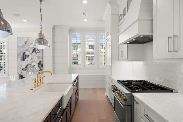a kitchen with a dining table cabinets and window