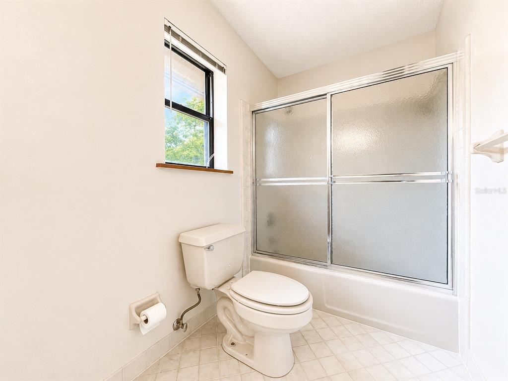 7119 Immokalee Road Keystone Heights, FL 32656 - Photo 28 of 50 a white toilet sitting next to a bathroom sink